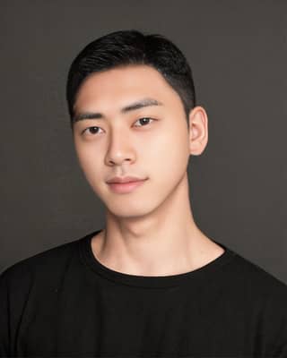 Asian man in a black shirt with fresh hairstyle.