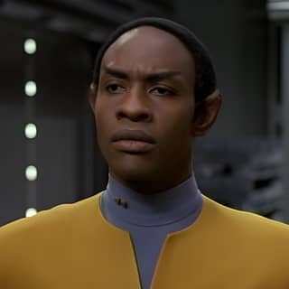 A black man in a Star Trek uniform staring at the camera.