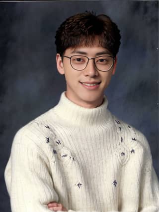 wearing glasses and a white sweater, the man played a role in a Korean drama.