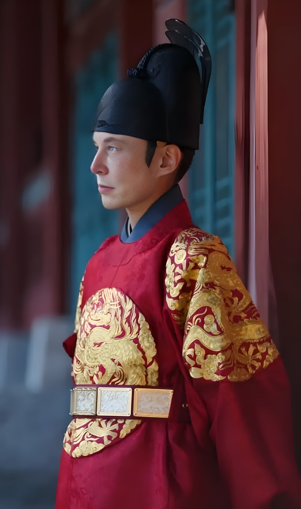 An Asian man is standing in front of a building in traditional Chinese clothing.