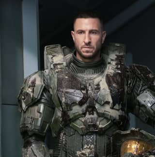 Halo character standing in a hallway, man in military uniform standing in a room.