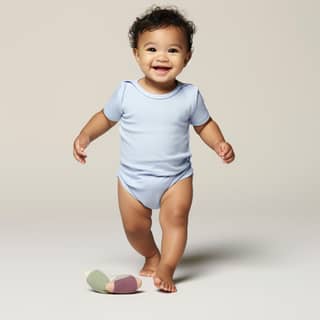 dark skinned latino looking baby in white salopette, a baby in a blue bodysuit running and smiling