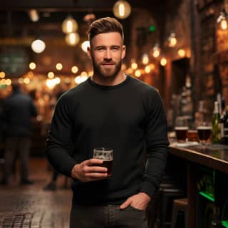 a plain black sweatshirt mockup while a full body irish male model wears it in irish pub studio light front view