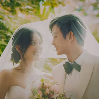 a bride and groom in a park