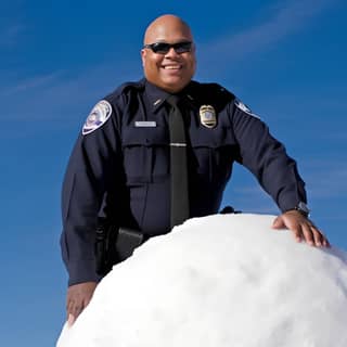 https://s mj run/CJMyK8y0lus a smiling simi valley police officer standing on top of rocky peak in simi valley lifting a 50