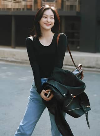 in jeans and a black top