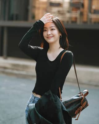 in jeans and a black top