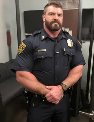 a police officer standing in front of a gym