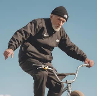 an old man riding a bike in the air