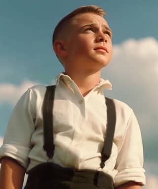 boy in a white shirt and suspenders