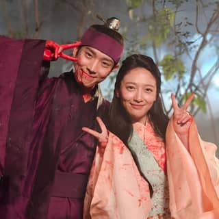 a couple dressed in traditional korean clothing posing for a picture