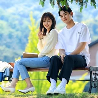 couple sitting on a bench in the park