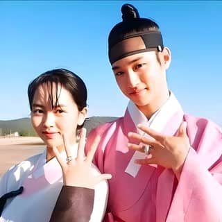 two people in traditional korean clothing pose for a picture