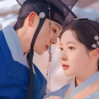 the couple is dressed in traditional korean clothing