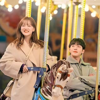 a couple riding a carousel together