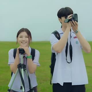 two people taking pictures with a camera