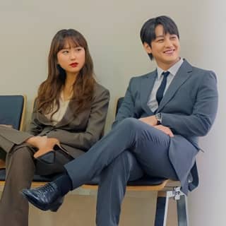 woman in business attire sitting on a bench