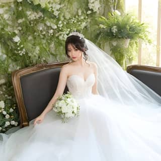 bride in a wedding dress sitting on a couch