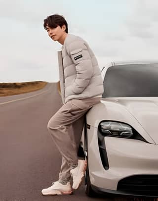 leaning on a white sports car